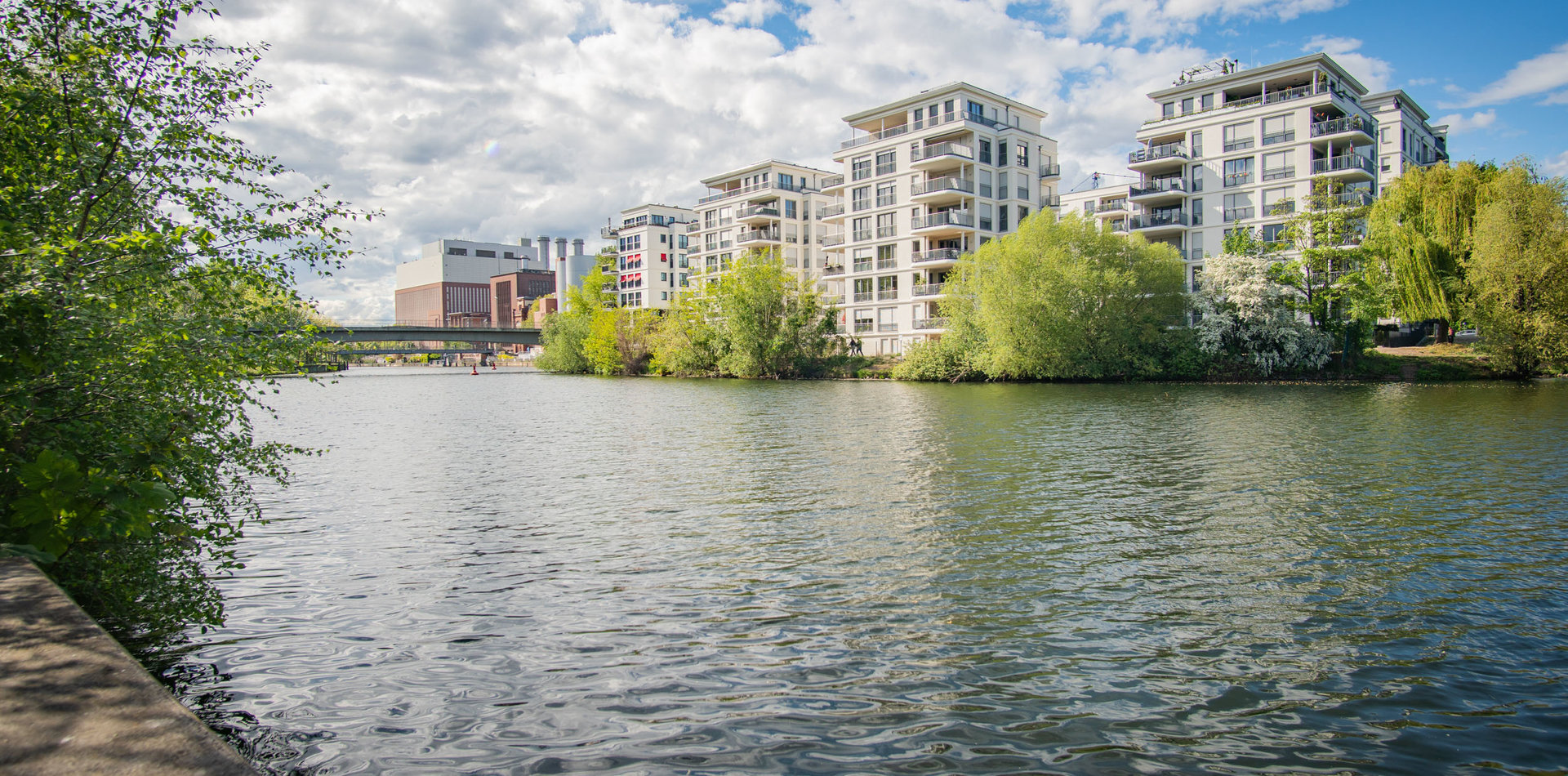 Blick vom Fluss auf eine urbane Wohnanlage